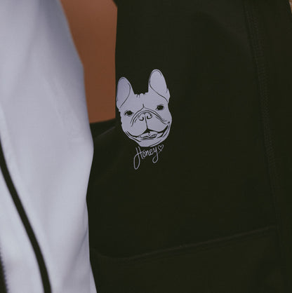 Close-up-detail-of-the-custom-graphic-design-on-the-black-garment-featuring-astylized-illustration-of-a-French-Bulldog-face-with-the-script-name-Honey-written-below-it