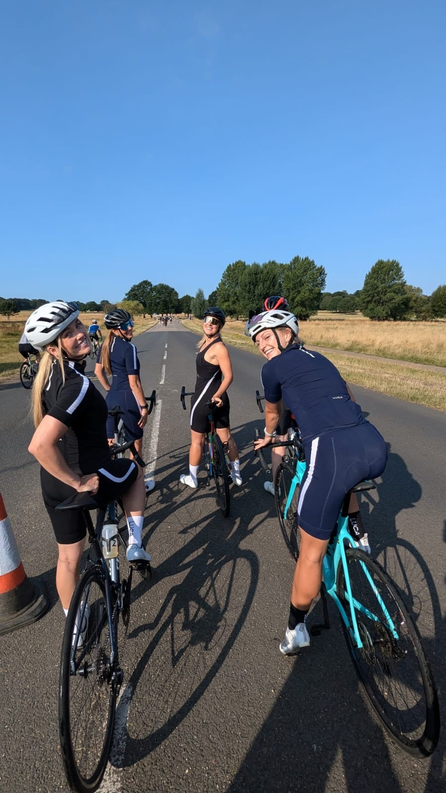 Cyclists-taking-a-break-on-an-empty-asphalt-road-on-a-clear-day