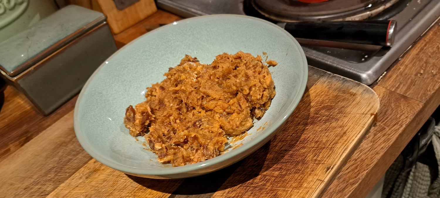 A-bowl-of-orange-brown-chunky-food- possibly-mashed-sweet-potatoes-a- stew-a-crumbly-dessert-served-in-a-light-blue-green-ceramic-bowl