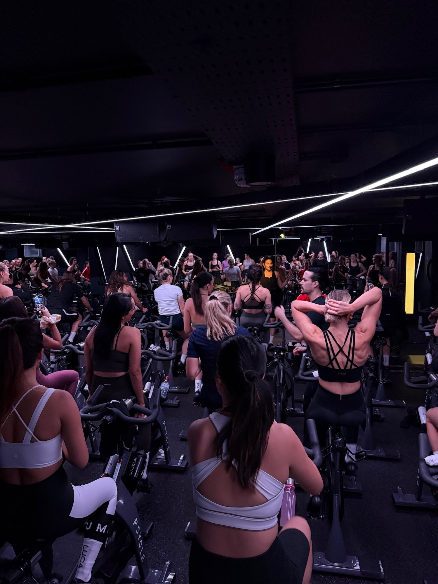 Large-group-of-people-actively- participating-in-an-intense-spin- class-showcasing-the-energy-of-the-studio-environment