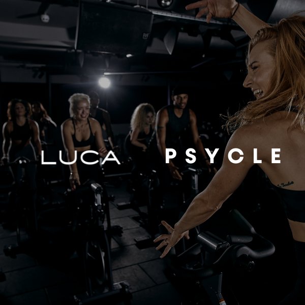 Group-of-people-exercising-during-a-cycling-fitness-class-with-the- words-"LUCA-PSYCLE"-on-the- screen