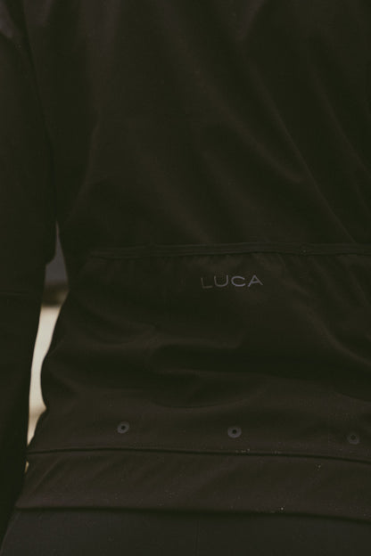 Back-detail-of-the-Luca-Momentum-Jacket-in-black-featuring-the-discrete-logo-and-horizontal-rear-pocket-design