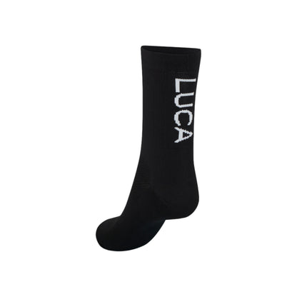 Single-black-Luca-cycling-sock-with-the-white-Luca-logo-printed-vertically-on-the-back-of-the-calf-shown-against-a-white-background
