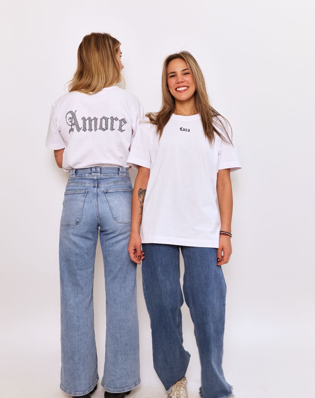 Lifestyle-photo-featuring-the-Luca- and-Amore-t-shirt-collection-on-two-models-wearing-casual-denim