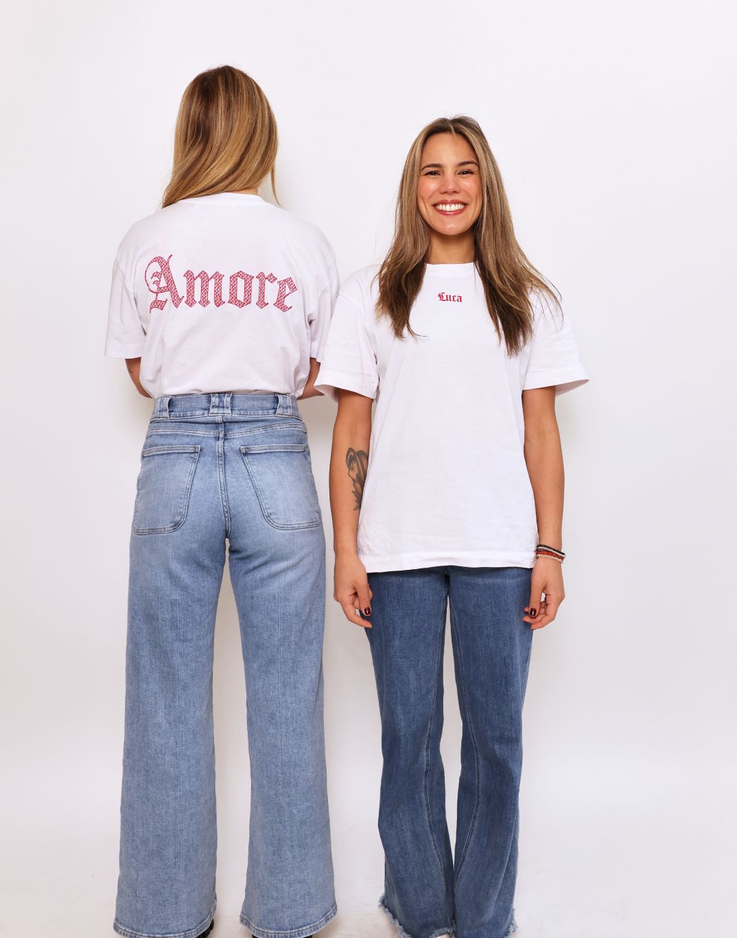 Lifestyle-shot-of-the-Luca-t-shirt- collection-highlighting-the-"Luca"- front-print-and-the-"Amore"-back- print-on-two-different-models