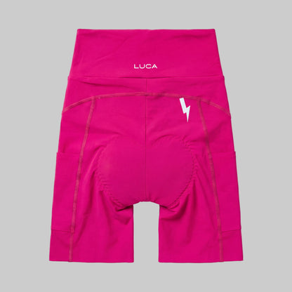 LUCA Empower women's high-waisted cycling shorts in hibiscus, back view with chamois and bolt detail