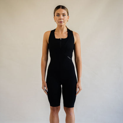 Cyclist wearing LUCA Road All-In-One Cargo bib shorts in black, front view