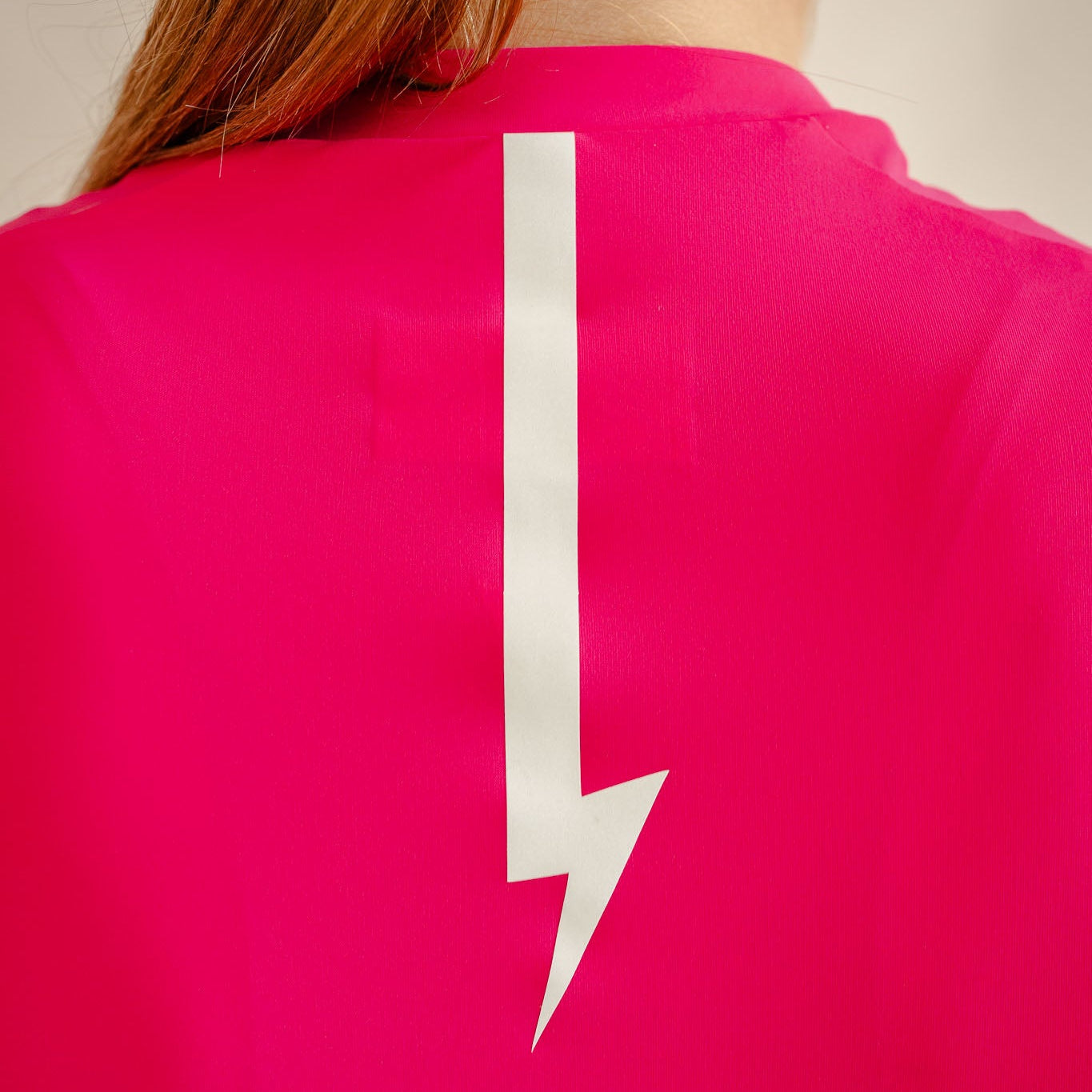 Soleil cycling jersey in hibiscus, reflective lightning bolt detail on back