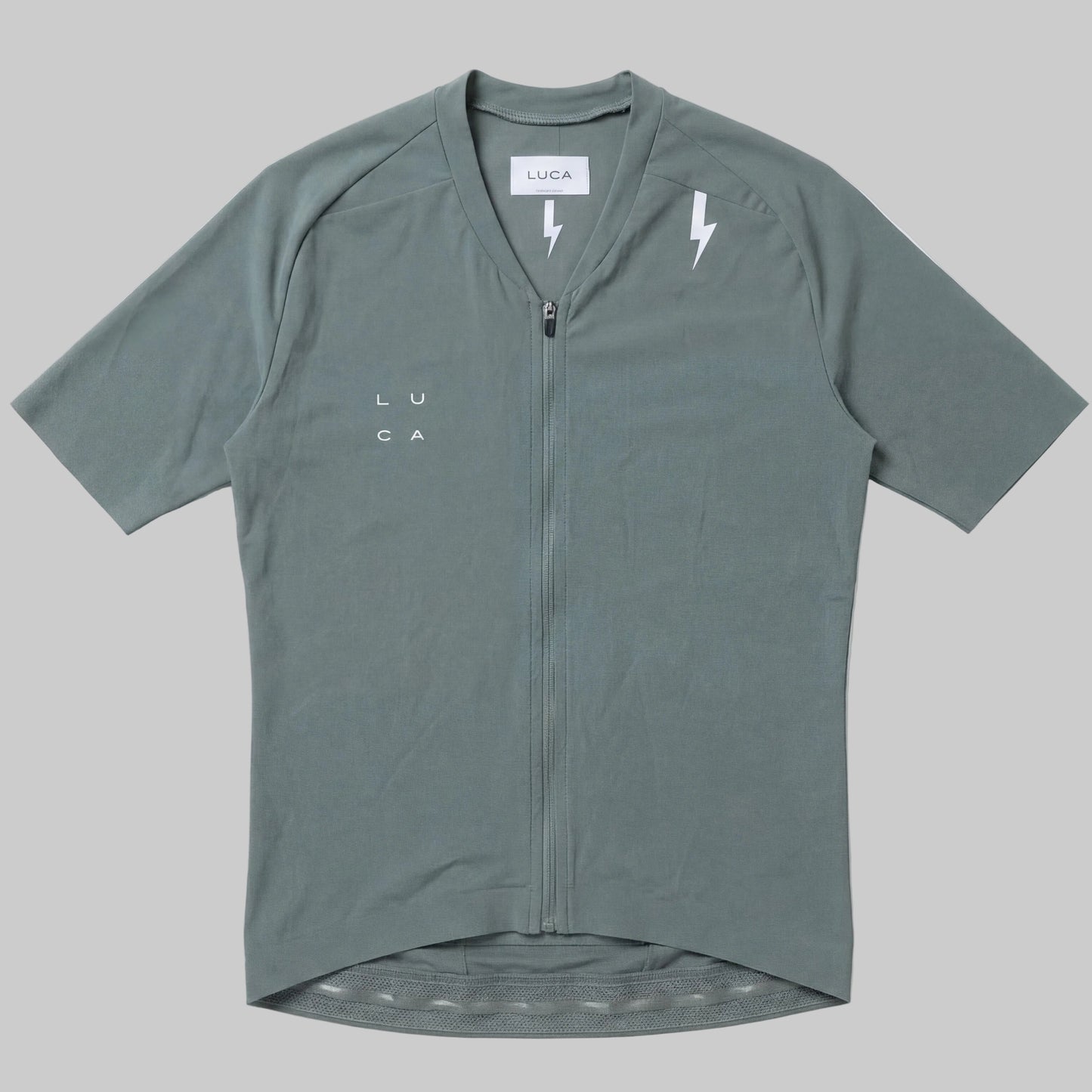 LUCA Soleil women's cycling jersey in matcha - front flat lay with V-neckline and bolt detail