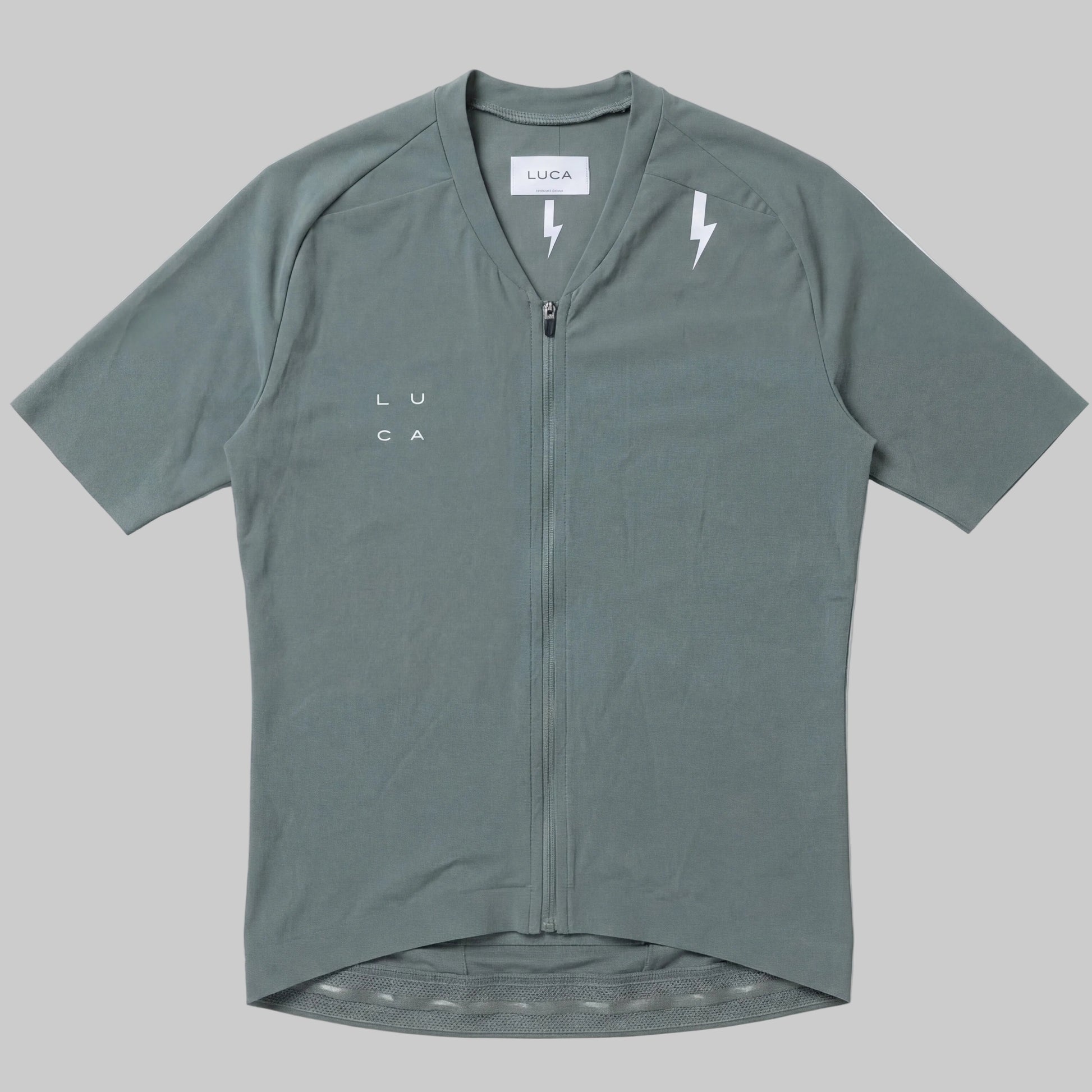 LUCA Soleil women's cycling jersey in matcha - front flat lay with V-neckline and bolt detail