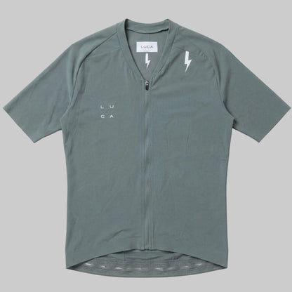 LUCA Soleil women's cycling jersey in matcha - front flat lay with V-neckline and bolt detail