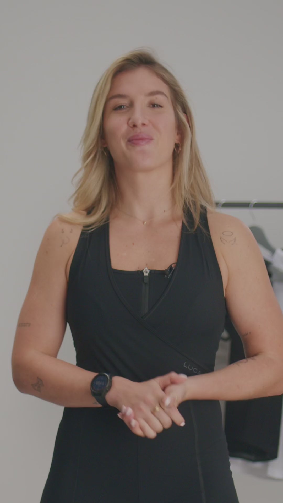 Video-promoting-a-versatile-black- athletic-jumpsuit-The-video-features-a-woman-explaining-that-this-new- version-is-designed-for-both- cycling- class-and-casual-wear-noting-that-the-bum-padding-and-reflective-white- stripes-were-removed-and-the-back- now-features-a-white-lightning-bolt- logo-for-a-sport- look